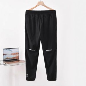 Black joggers with reflective knee slits, product photo from the seller